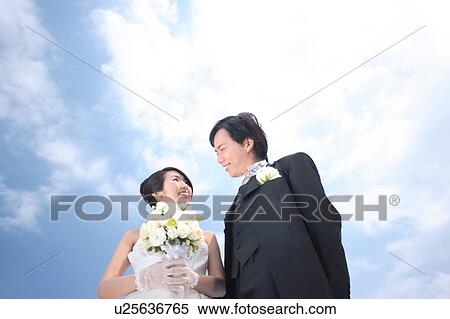 Bride and groom looking at each other View Large Photo Image Stock Photography - Bride and groom looking at each other. Fotosearch