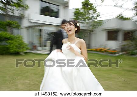 Bride and groom running on lawn, blurred motion View Large Photo Image Stock Image - Bride and groom running on lawn, blurred motion. Fotosearch