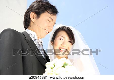 Stock Image - Bride and groom smiling. Fotosearch