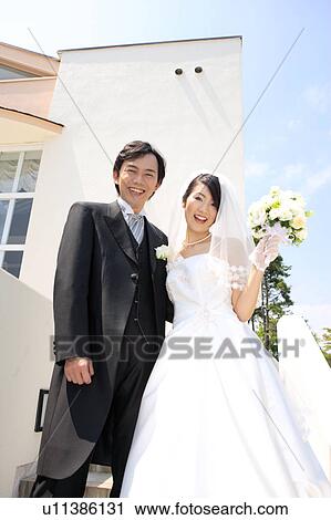 Bride and groom standing View Large Photo Image Stock Image - Bride and groom standing. Fotosearch