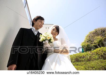 Bride and groom standing View Large Photo Image Stock Image - Bride and groom standing. Fotosearch