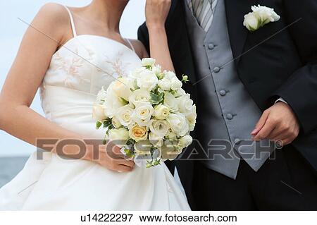 Stock Photo - Bride and groom with flowers. Fotosearch