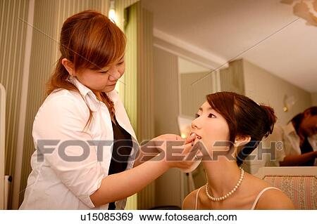 Bride having lipstick applied View Large Photo Image Stock Photo - Bride having lipstick applied. Fotosearch