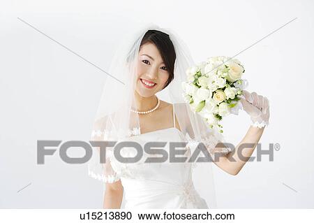 Bride holding bouquet of flowers View Large Photo Image Stock Image - Bride holding bouquet of flowers. Fotosearch