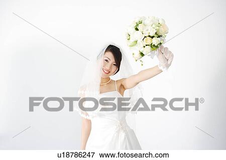 Stock Photo - Bride holding bouquet of flowers. Fotosearch