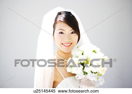 Bride holding bouquet of flowers View Large Photo Image Stock Photography - Bride holding bouquet of flowers. Fotosearch