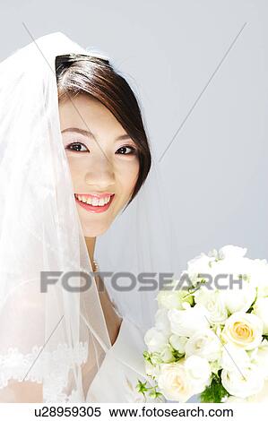 Stock Photography - Bride holding bouquet of flowers. Fotosearch