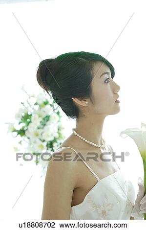 Bride holding flowers View Large Photo Image Stock Image - Bride holding flowers. Fotosearch