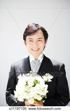 Groom holding bouquet of flowers View Large Photo Image Stock Photography - Groom holding bouquet of flowers. Fotosearch
