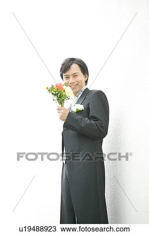 Groom holding flowers View Large Photo Image Stock Image - Groom holding flowers. Fotosearch