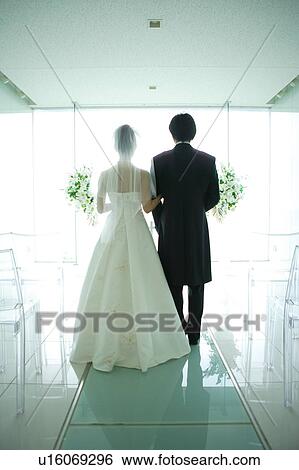 Rear view of bride and groom at altar View Large Photo Image Stock Photograph - Rear view of bride and groom at altar. Fotosearch