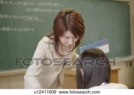 Female teacher teaching in classroom View Large Photo Image Stock Photo - Female teacher teaching in classroom. Fotosearch