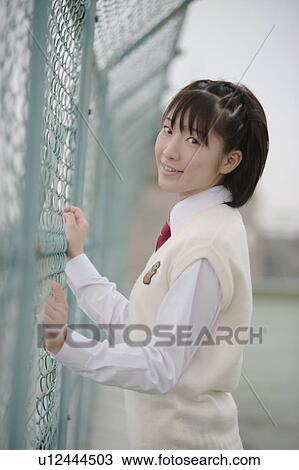 High school girl standing in schoolyard View Large Photo Image Stock Image - High school girl standing in schoolyard. Fotosearch