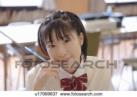 Stock Photo - High school girl studying in library. Fotosearch