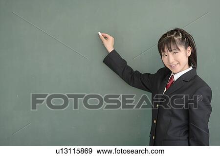 High school girl writing on blackboard View Large Photo Image Stock Photo - High school girl writing on blackboard. Fotosearch