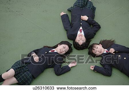 Three high school girls lying down View Large Photo Image Stock Image - Three high school girls lying down. Fotosearch