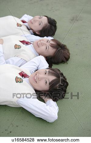 Stock Photo - Three high school girls lying down. Fotosearch