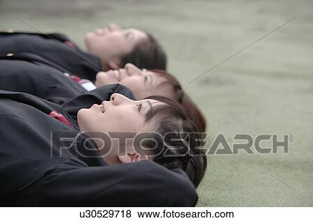 Stock Photo - Three high school girls lying down. Fotosearch