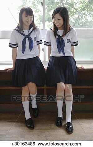 Stock Photography - Two high school girls in classroom. Fotosearch