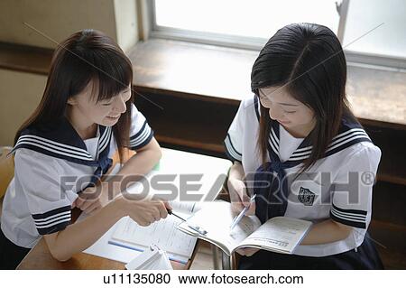 Stock Image - Two high school girls studying. Fotosearch