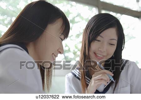 Stock Image - Two high school girls studying. Fotosearch