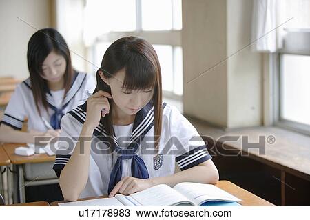 Stock Image - Two high school girls studying. Fotosearch