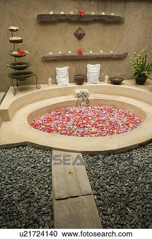 Stock Image - Bath filled with flower petals. Fotosearch