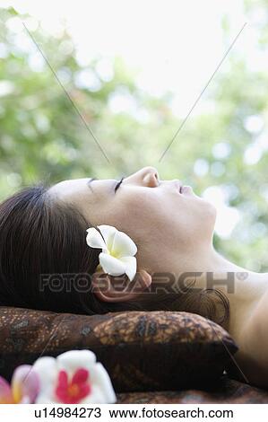Close-up of young woman lying down View Large Photo Image Stock Image - Close-up of young woman lying down. Fotosearch