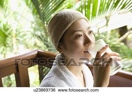 Stock Photograph - Young woman drinking glass of water. Fotosearch