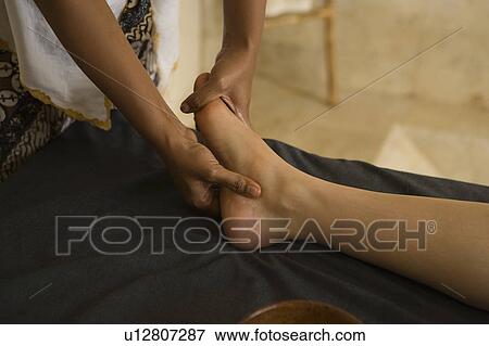 Stock Photo - Young woman having foot massage. Fotosearch