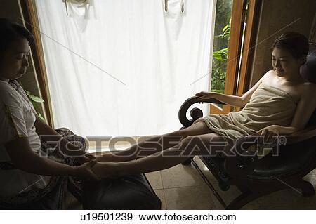 Stock Photo - Young woman having foot massage. Fotosearch