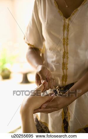 Stock Photography - Young woman having hand massage. Fotosearch
