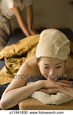 Stock Image - Young woman having leg massage. Fotosearch