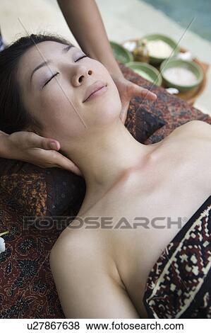 Stock Photo - Young woman having neck massage. Fotosearch