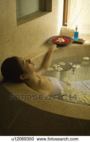 Young woman taking bath with flower petals View Large Photo Image Stock Image - Young woman taking bath with flower petals. Fotosearch
