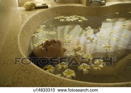 Young woman taking bath with flower petals View Large Photo Image Stock Image - Young woman taking bath with flower petals. Fotosearch