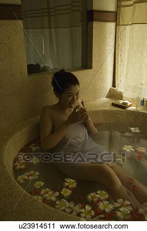 Young woman taking bath with flower petals View Large Photo Image Stock Image - Young woman taking bath with flower petals. Fotosearch