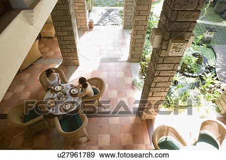 Stock Photo - Two young women eating at table. Fotosearch