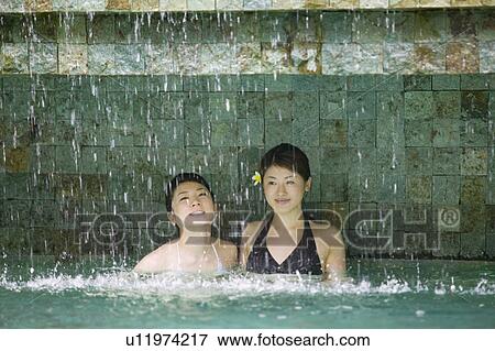 Two young women in swimming pool View Large Photo Image Stock Photo - Two young women in swimming pool. Fotosearch