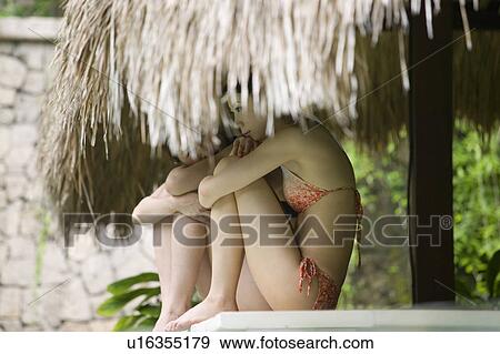 Stock Photo - Two young women sitting under gazebo. Fotosearch