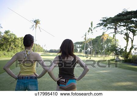 Stock Image - Two young women standing. Fotosearch