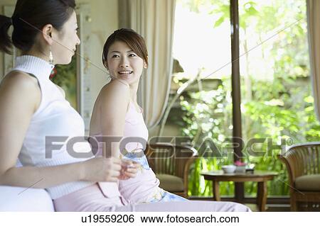 Stock Photograph - Two young women talking. Fotosearch