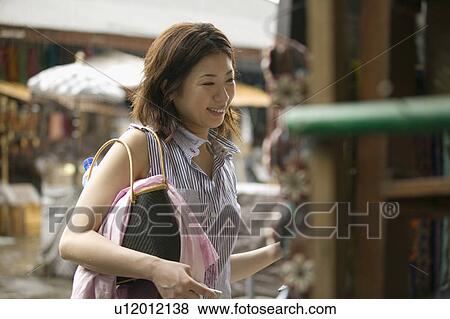 Stock Photo - Young woman shopping. Fotosearch