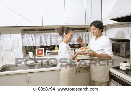 Picture - Mature couple cooking. Fotosearch