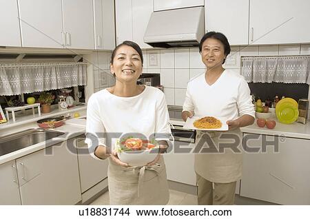 Picture - Mature couple cooking. Fotosearch