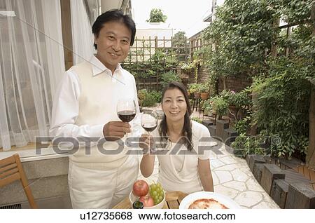 Mature couple having wine outside View Large Photo Image Stock Photo - Mature couple having wine outside. Fotosearch