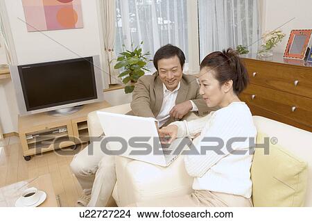 Mature couple looking at computer screen View Large Photo Image Picture - Mature couple looking at computer screen. Fotosearch
