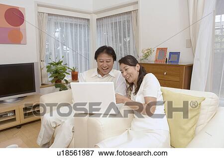 Stock Photo - Mature couple looking at computer screen. Fotosearch