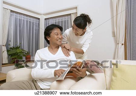 Stock Photo - Mature couple reading magazine. Fotosearch