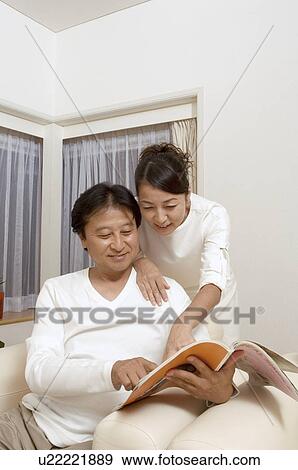 Mature couple reading magazine View Large Photo Image Stock Photo - Mature couple reading magazine. Fotosearch